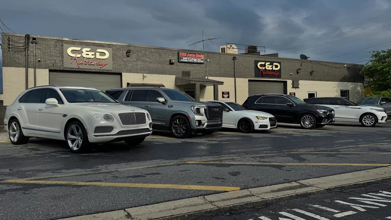 C&D Auto Body technicians repairing a vehicle